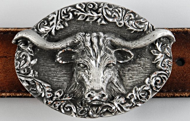 oval pewter belt buckle, Texas longhorn head on wood texture with leaf work